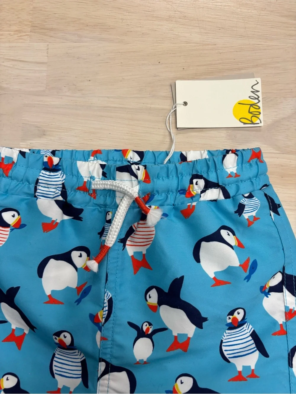 New Baby Boden puffin swim trunks